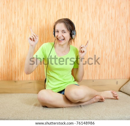 young woman listen to the music with head phones
