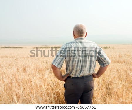 A man standing in field of wheat