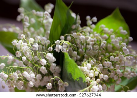 Beautiful bouquet of lily of  valley is on  table