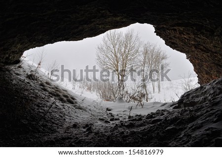 Snow falling through a mine entrance.
