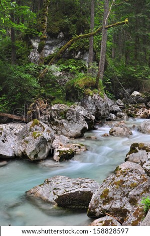 A creek cutting through limestone rocks in Bavarian Alps