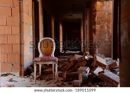 An abandoned antique chair in an abandoned building.