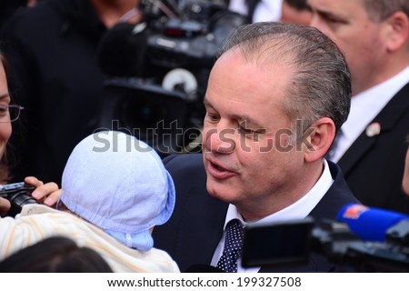 President Andrej Kiska holding a baby during the presidential inauguration on June 15, 2014 in Bratislava, Slovakia.