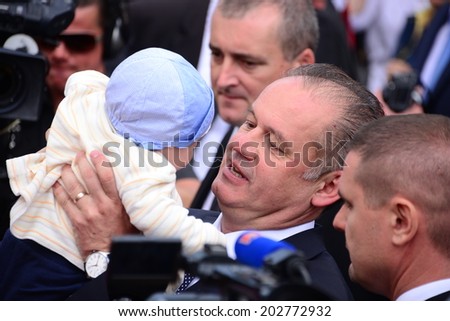 President Andrej Kiska holding a baby during the presidential inauguration on June 15, 2014 in Bratislava, Slovakia.