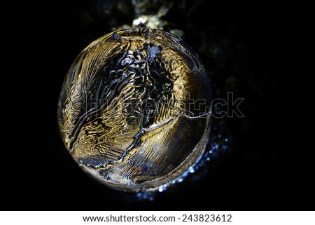 Reflection of light in a thawing ice stalagmite inside an abandoned mine in Banska Stiavnica, Slovakia.