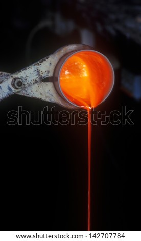 Melting gold in a crucible to manufacture gold grains.