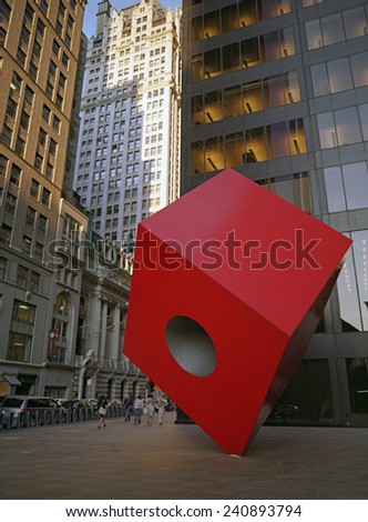 New York City, USA - June 24, 2014: Red Cube on the street. The Red Cube is a sculpture by Isamu Noguchi and is located in front of 140 Broadway, between Liberty and Cedar Streets in New York City.