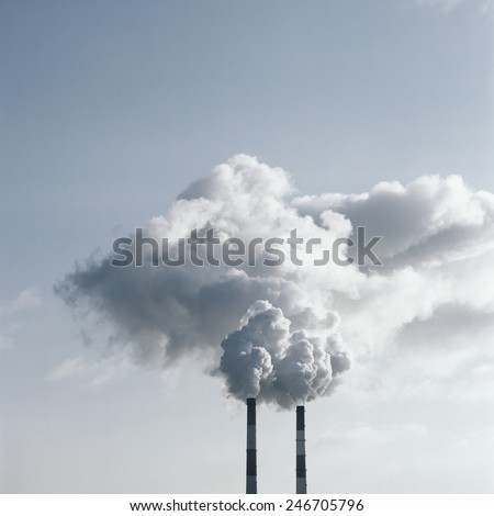 Air pollution by smoke coming out of two factory chimneys. Scanned film source.