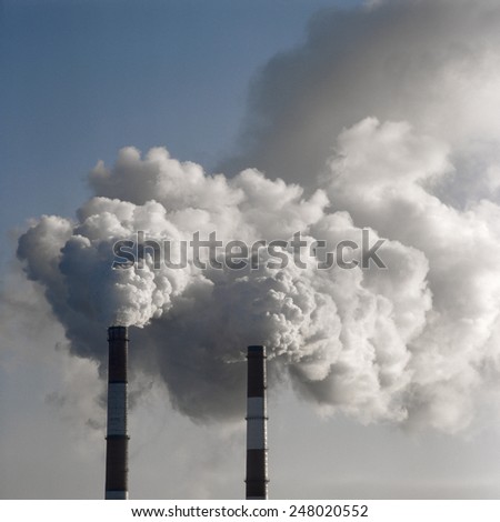 Air pollution by smoke coming out of two factory chimneys. Scanned film source.