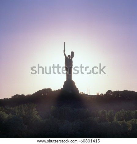 Monument to Motherland with a sunset in the background. Kyiv, Ukraine.