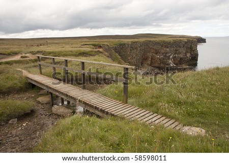 Wooden bridge and trail at Orkney islands