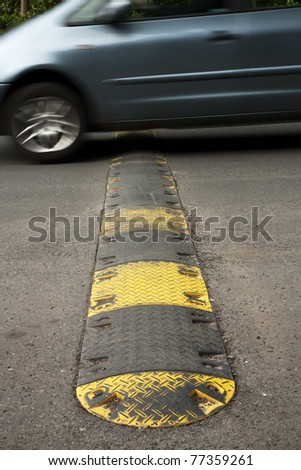 Speed bump on a road when a car is passing