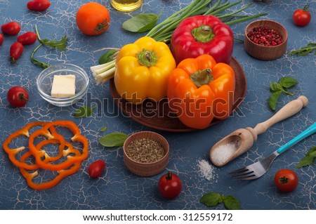 Multi-colored sweet peppers on a blue board; the substrate for the menu bars and restaurants; recipes; ingredients for cooking; healthy eating; Tips for weight loss; diet