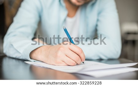 Man writing at the desk