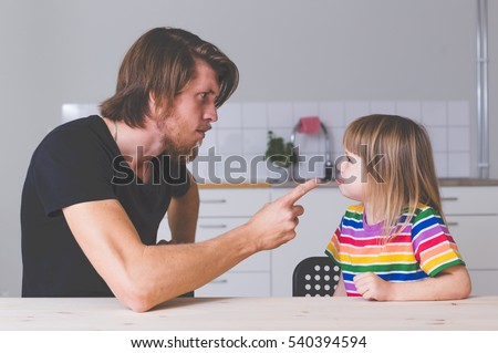 young father fighting with daughter in preschool age, screaming and talking strict with her at home on kitchen