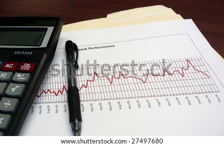 Chart displaying negative results with a calculator and pen.