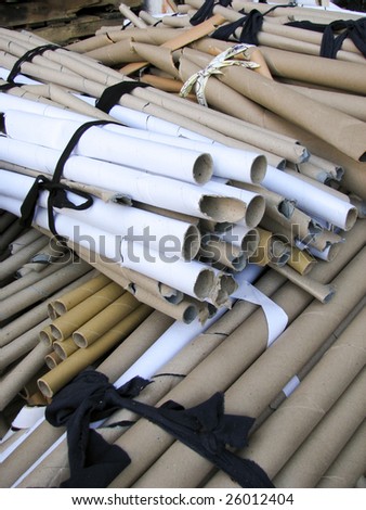 Bundles of cardboard tubes wrapped in black cloth ribbon