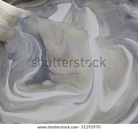Can of cream paint that has separated and looks like swirls of brown