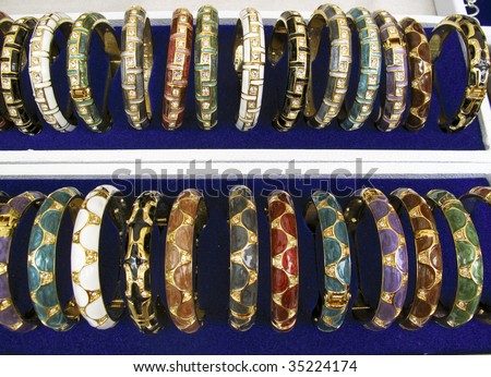 Rows of jeweled and gold bangles at a market