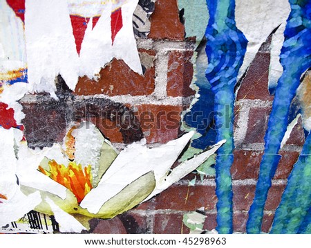 stock photo Old brick wall with graffiti and parts of old posters peeling