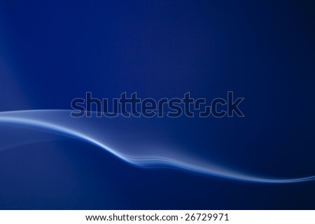 Blue whisp of smoke flowing horizontally against deep royal blue background.