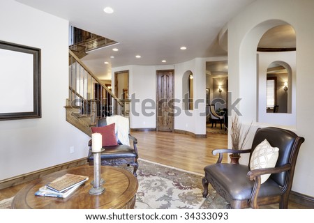 View of home\'s foyer and entrance with wood floors