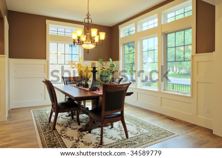 Large dining room with wood floors and area rug