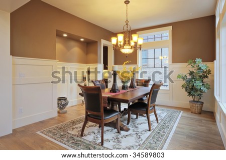 Large dining room with wood floors and area rug
