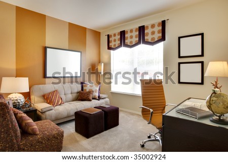 Small office space room with orange accent walls and desk