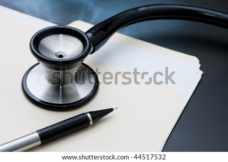 Medical Records with X Ray and Stethoscope. Focus  on pen tip.