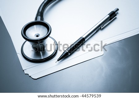 Blue Toned Image. Medical Records with X Ray and Stethoscope