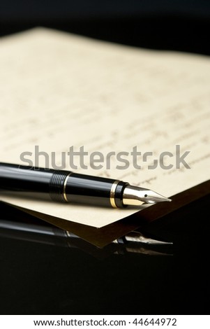 Vertical view of Fountain Pen and Letter with extreme shallow depth of field. Focus on very end of nib on pen.