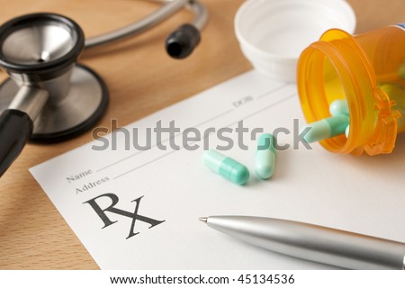 Critical focus on tip of pen. Stethoscope and bottle cap beyond depth of field.
