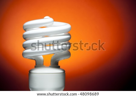 Fluorescent Bulb on Orange Background. Focus on edges of bulb tube and base