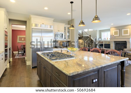 Luxury kitchen from angle overlooking center cooking area island.
