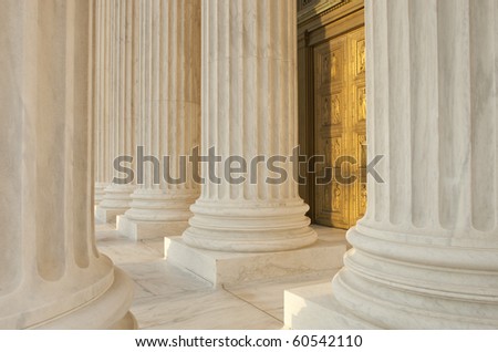 Supreme Court Column Details. Sunset orange light cast across scene.