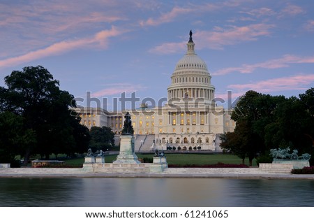 US Capitol at dusk from across reflecting pool. Focus on capitol dome and building.