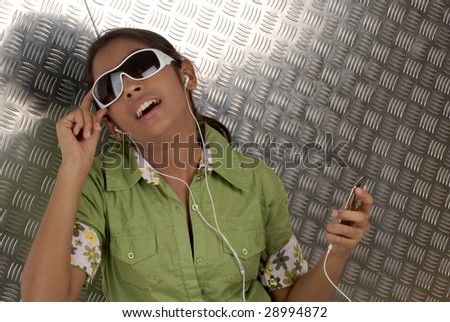 beautiful girl listening music on her portable CD player wearing sunglasses