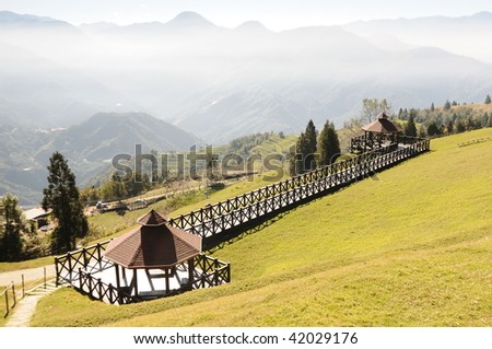 two pavilions with a mountain landscape