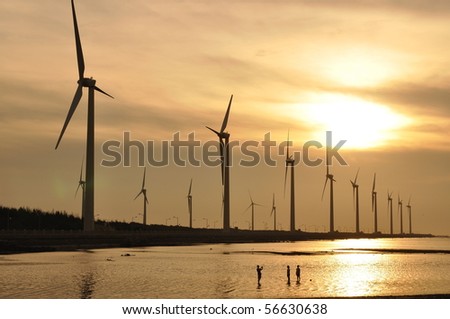 golden sunset with wind-power station