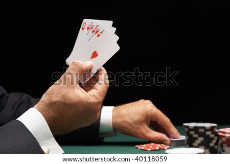 Poker player winning hand of cards royal flush with casino chips