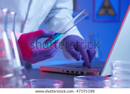 Close up of biotechnology research in laboratory blue lighting