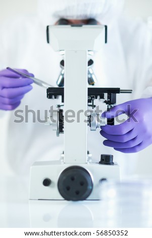 Forensic scientist examined evidence under microscope selective focus