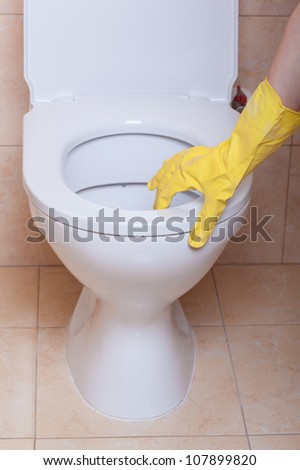 WC hygiene concept, hand in yellow glove making signs