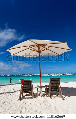 Sun umbrella with Santa Claus Hat on chairs