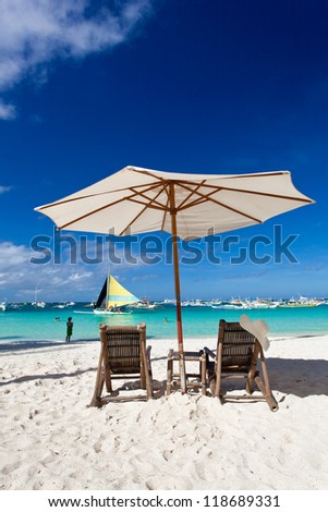Sun umbrella with Sun Hat on chair