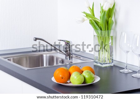 Healthy lifestyle, apples and oranges in white interior kitchen