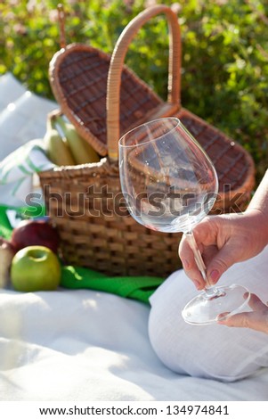 Woman holding empty wineglass, outdoor