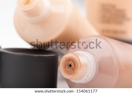 Tubes with make up liquid foundation, closeup on white background