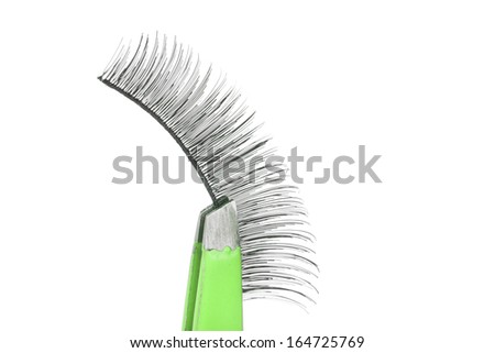 False lashes and green pincers, closeup on white background